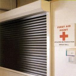 A commercial security shutter on a chemist shop